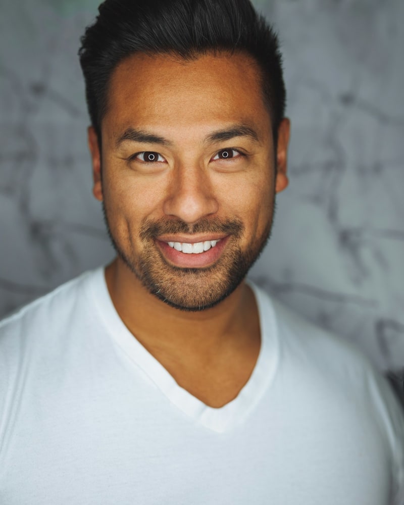 Studio headshot of a man in a jacket