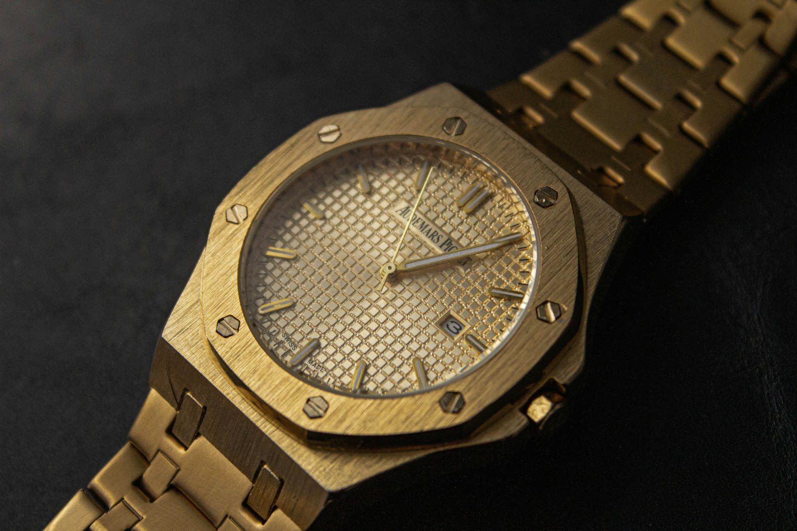 Gold wristwatch on a dark background