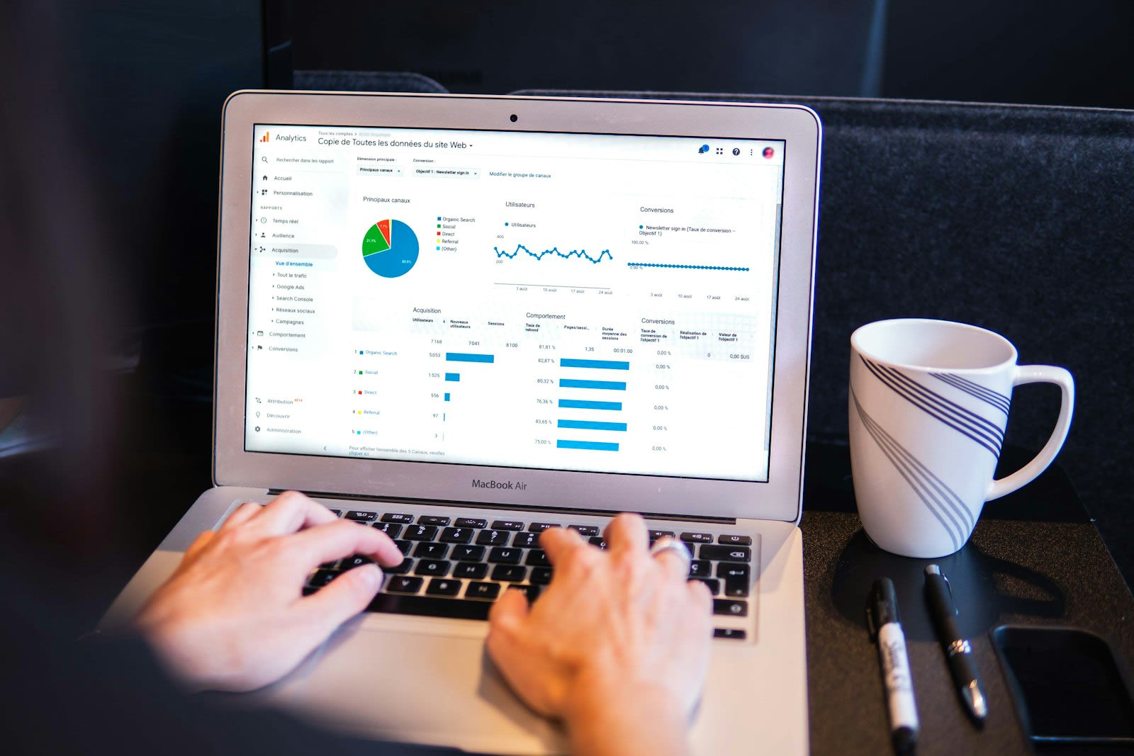 Person reviewing analytics charts on a MacBook